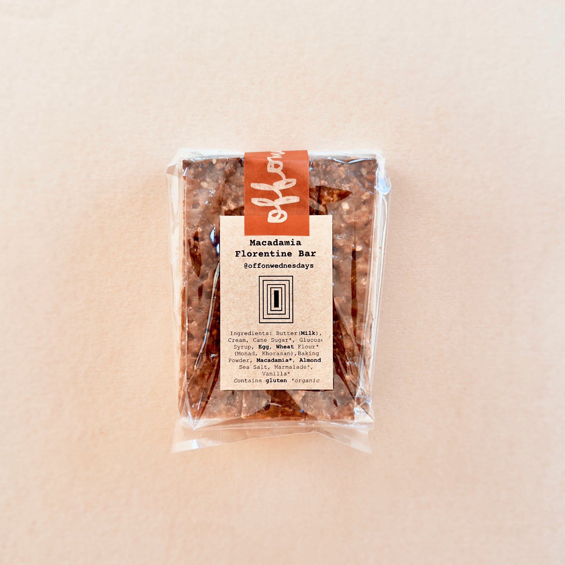 Packaged Macadamia Florentine Bar on a beige background
