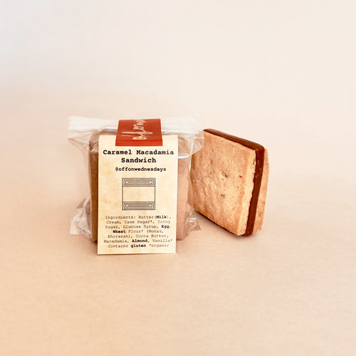 Caramel macadamia sandwich in packaging on a beige background